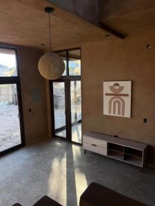 a living room with a couch and a pendant light at SAYA Coliving in El Paredón Buena Vista