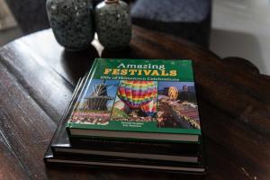 a stack of books sitting on a table at Little Noone in Jackson