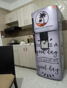a refrigerator with writing on it in a kitchen at Right Lang Deh Soh in San Andrés