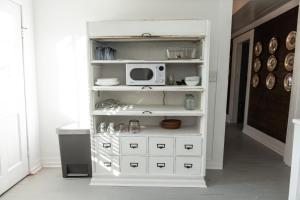 a white cabinet with a microwave on top of it at Little Noone in Jackson +30 photos