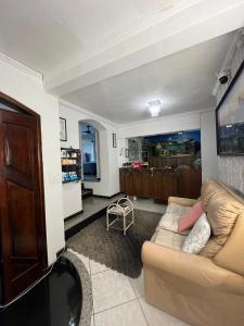 a living room with a couch and a table at Hostel Anprado #1 Kit café incluso, Próx-Aeroporto de Guarulhos in Guarulhos