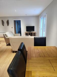 a living room with a couch and a tv at Durham Norwood detached Bungalow in Trimdon Grange