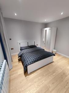 a bedroom with a bed and a wooden floor at Durham Norwood detached Bungalow in Trimdon Grange