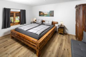 a bedroom with a large wooden bed in a room at Rauchenbichlhof in Ruhpolding