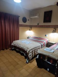 En eller flere senge i et værelse på Hotel & Restaurant Las Brisas