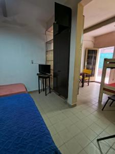 a bedroom with a bed and a desk with a laptop at Departamento PB 1 Centro Pileta in Formosa