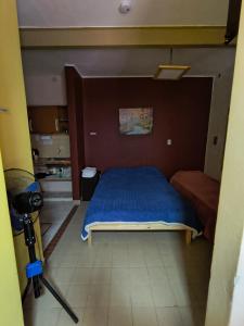 a bedroom with a bed with a blue blanket at Departamento PB 1 Centro Pileta in Formosa +2 photos