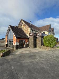 a building with a parking lot in front of it at The Lobster Pot in Ilfracombe