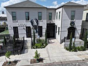 a large white building with a sign on it at Blue Crawfish Boutique Hotel & Pool Bar in New Orleans