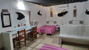 a bedroom with a bed and a tub and a sink at Casa del Jaibo in Heroica Alvarado