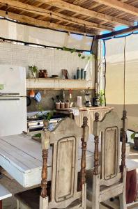 a kitchen with a table and a stove and a refrigerator at Casa Costa Sirena in El Gigante