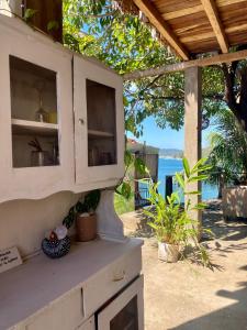 a white kitchen with a view of the ocean at Casa Costa Sirena in El Gigante