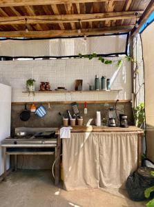 a kitchen with a table with a counter top at Casa Costa Sirena in El Gigante +7 photos