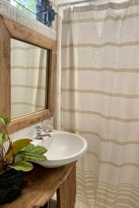 a bathroom with a sink and a shower curtain at Casa Costa Sirena in El Gigante