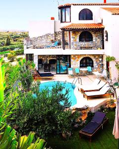 a house with a swimming pool in front of it at Elia Woodstone Houses in Elaía