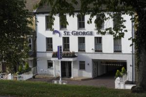 a white building with a st george sign on it at St George Hotel Rochester-Chatham in Chatham