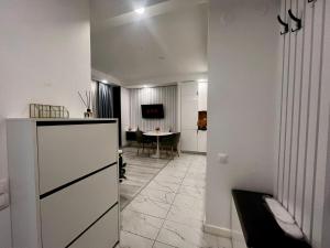 a hallway with a living room with a table at Nivora apartament #freeparking in Tunari +4 photos