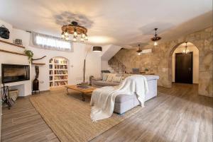 a living room with a couch and a table at Alghero Villa Flamingo Luxury Resort with exclusive pool, gym and SPA in Alghero +113 photos