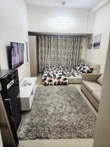a living room with a bed and a couch at Ajman Luxury Downtown B9OO7 in Ajman 