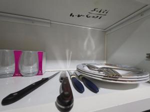 a table with a knife and a plate and glasses at Ajman Luxury Downtown B9OO7 in Ajman 