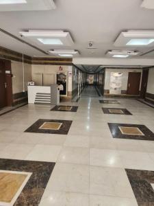 a large room with a tile floor and a lobby at Ajman Luxury Downtown B9OO7 in Ajman 