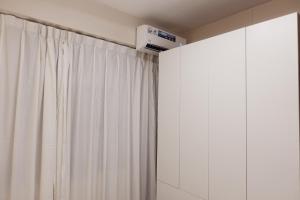a room with a white curtain and a heater at Nadi Ease Stay Near McDonalds in Nadi