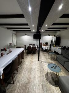 a room with a long table and chairs and a couch at View Racha in Ambrolauri
