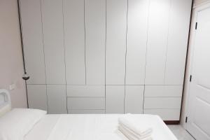 a white room with a bed and a shower at Nadi Ease Stay Near McDonalds in Nadi