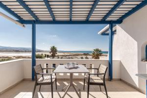 a patio with a table and chairs on a balcony at Crystal Naxos 1 Studios at Mikri Vigla in Mikri Vigla