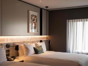 a hotel room with a bed and a window at Crowne Plaza Auckland by IHG in Auckland