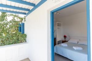 a bedroom with a bed and a window at Crystal Naxos 1 Studios at Mikri Vigla in Mikri Vigla