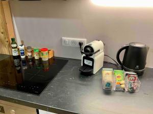 a kitchen counter with a coffee maker and a toaster at Superbe terrasse proximité centre in Morzine