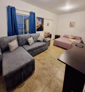 a living room with a couch and a bed at Colonial Travel Popayán in Popayan