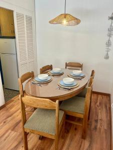 a dining room table with four chairs and a tablewered at Edificio Carbe Punta del Este - Frente al Mar -parada 2 de la Mansa in Punta del Este