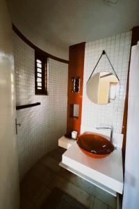 a bathroom with a wooden sink and a mirror at Casa do Prãna in Guajiru +19 photos