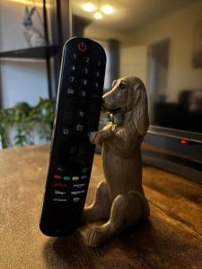 a remote control sitting on top of a dog statue at StoneHaven Townhouse in Donegal +9 photos