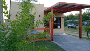 a view of a house with a pergola at Rojavitiva in General Belgrano