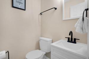 a bathroom with a white toilet and a sink at Carbon Ridge 300mbps WiFi - Dog Friendly in Oak Grove +27 photos