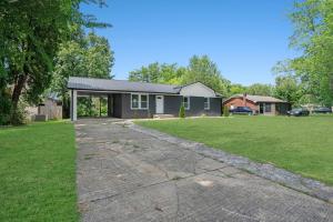 a house with a driveway in front of a yard at Carbon Ridge 300mbps WiFi - Dog Friendly in Oak Grove