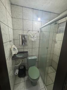 a bathroom with a green toilet and a shower at Recantodomarsaojose in São José de Ribamar +19 photos