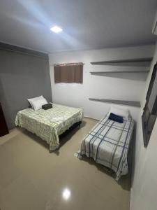 a room with two beds in a room at Recantodomarsaojose in São José de Ribamar