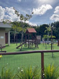 a park with a playground with a swing set at CAMINHOS do MAR ACOMODAÇÕES in Parnamirim