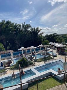 a group of people in a pool at a resort at CAMINHOS do MAR ACOMODAÇÕES in Parnamirim