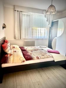 un letto in una stanza con una finestra di Termál Apartman a Tiszaújváros
