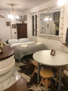 a bedroom with a bed and a table and a table at Casa Lago Como in Perledo