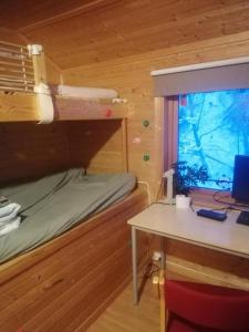 a bedroom with a bunk bed and a desk with a computer at The top half of a house with sea view in Steinkjer