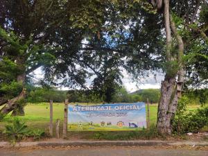 an emergency official sign in a park with trees at CasaJuan in Roldanillo
