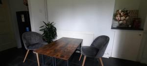 a wooden table and two chairs in a room at Eighteen in Jesmond