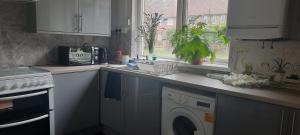 a kitchen with a washing machine and a window at Eighteen in Jesmond