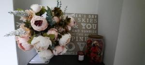 a bouquet of flowers on a shelf next to a sign at Eighteen in Jesmond